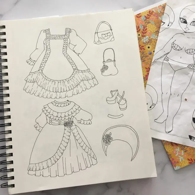 A sketchbook illustration of gothic Lolita fashions.